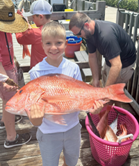 Boy Holding a Giant Red Snapper