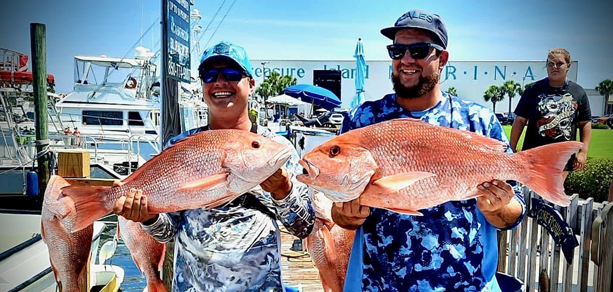 Two Anglers holding Large Red Snappers
