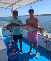 Two Young Men Showing Off Their Catch
